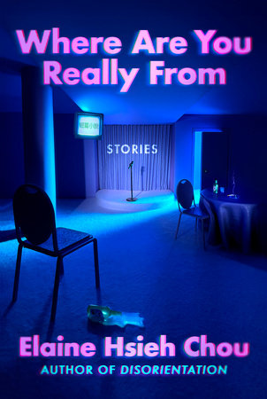 The cover of the book Where Are You Really From featuring a dark empty room with a microphone at the front